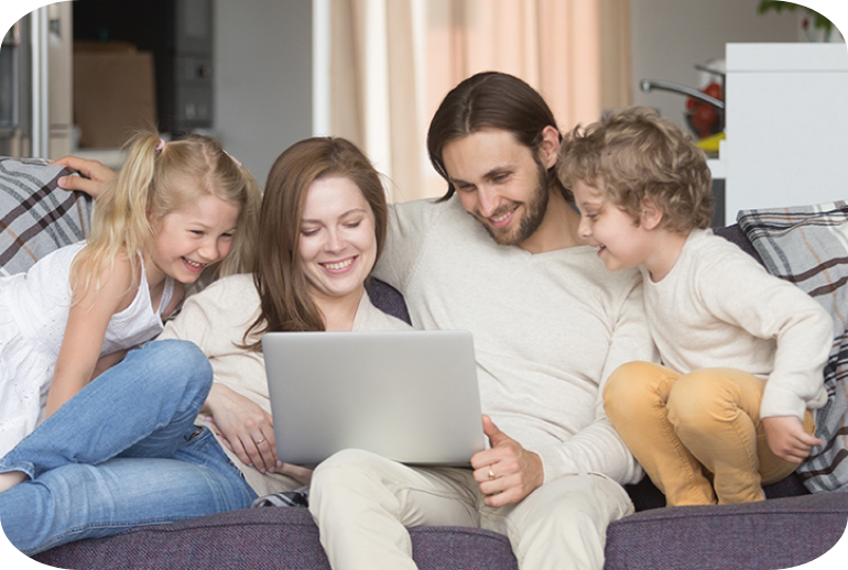 Family at home together looking at a laptop