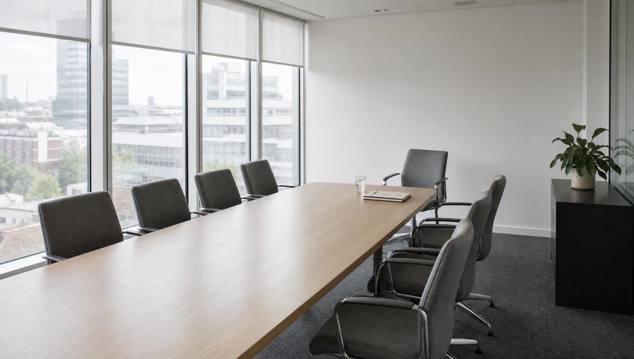 Empty boardroom in daylight with one chair turned away from the table, representing the Co-op chair standing down after the 2025 cyberattack.